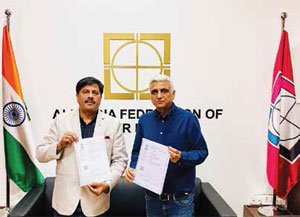 The signed agreement held by Raveendra Joshi (Left), President, AIPMP and Anil Arora (Right), Director, PPCPL